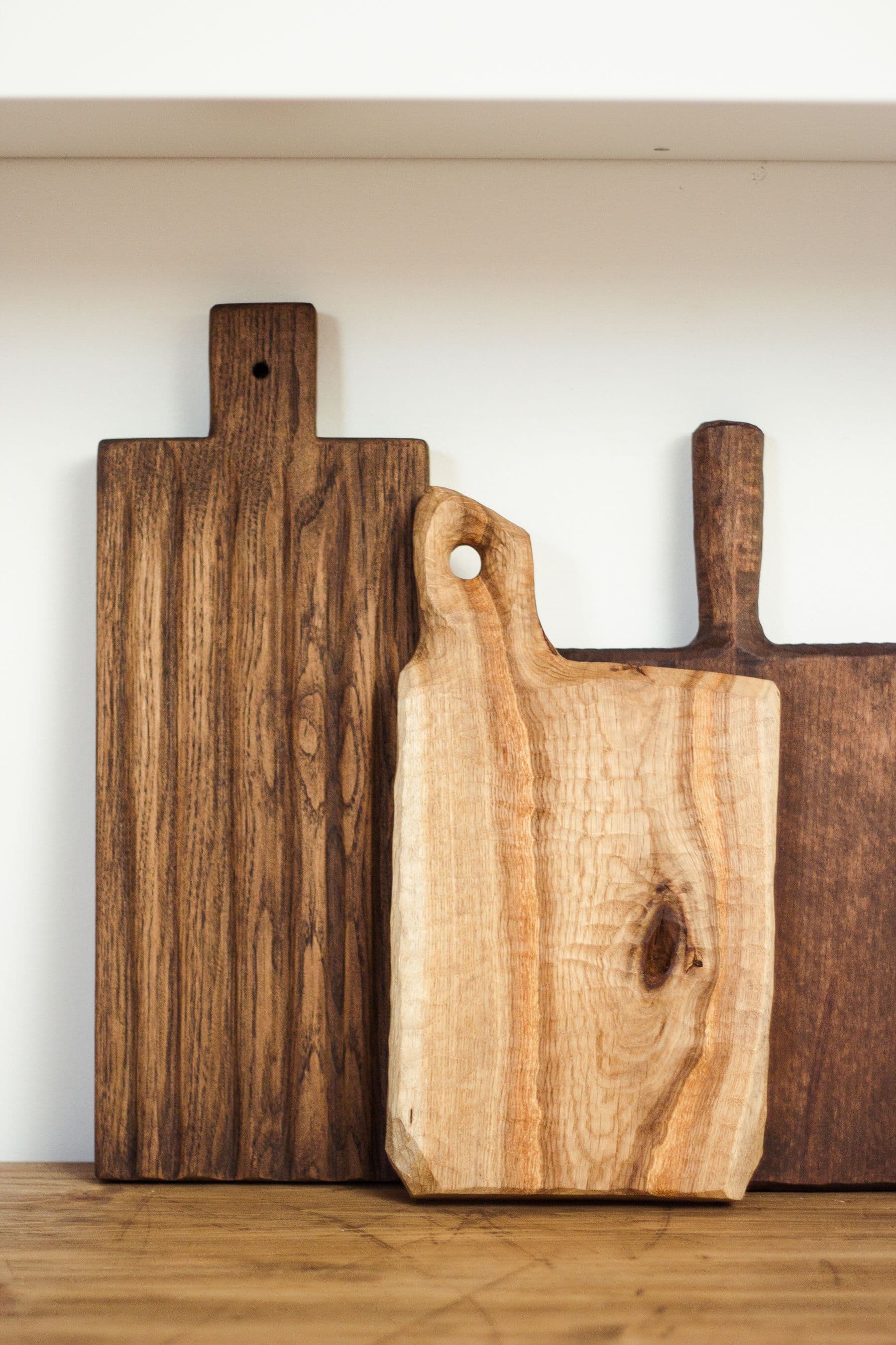 Handmade wooden boards against a clean white wall