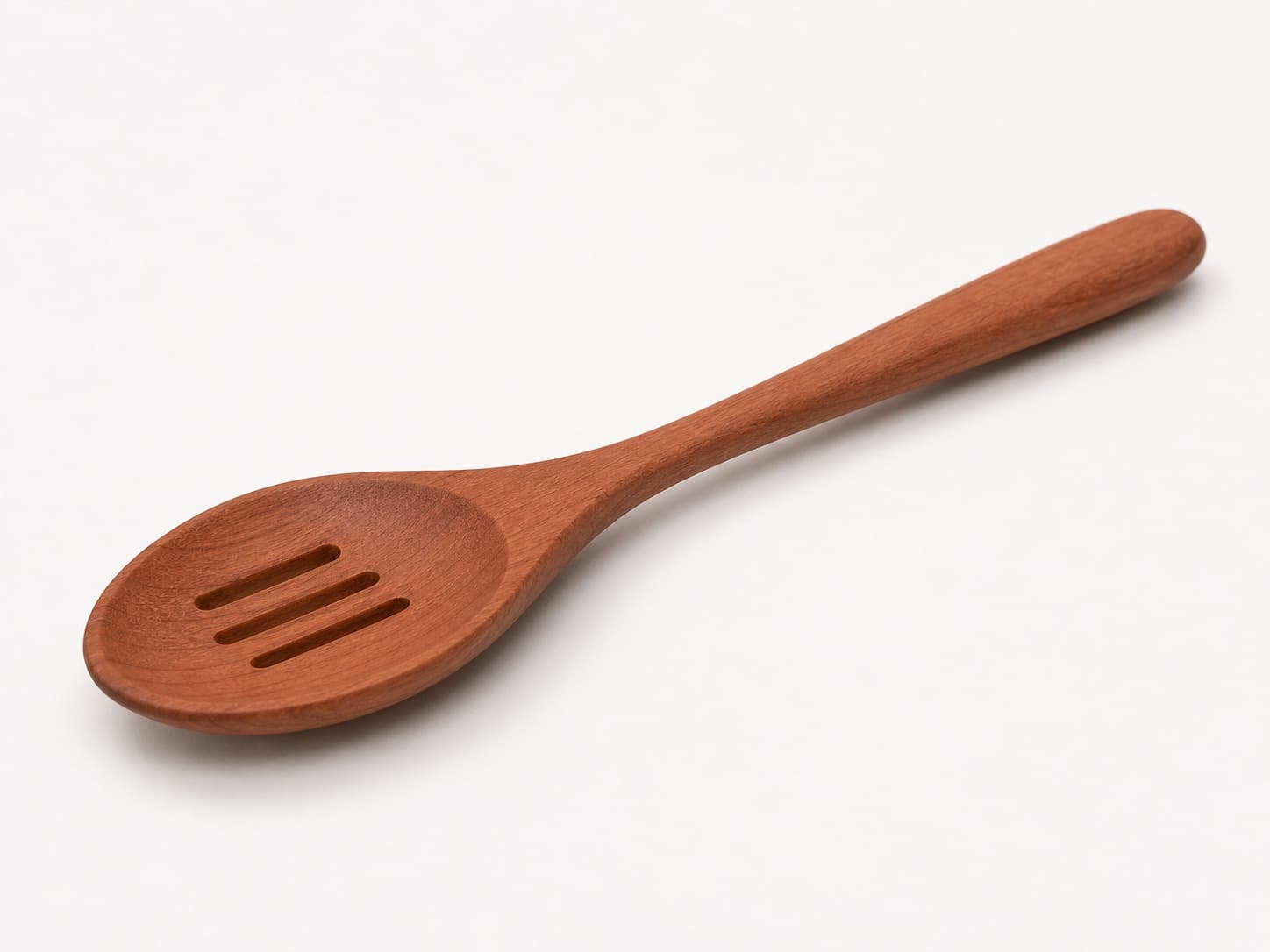Low side angle showing the thickness and edge profile of Slotted Cooking Spoon