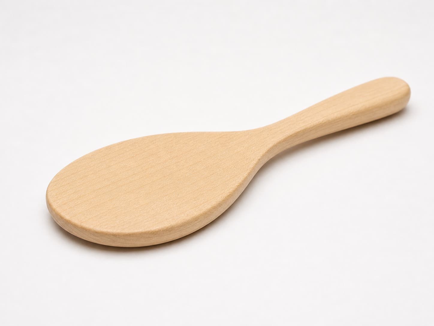 Low side angle showing the thickness and edge profile of Rounded Maple Rice Paddle