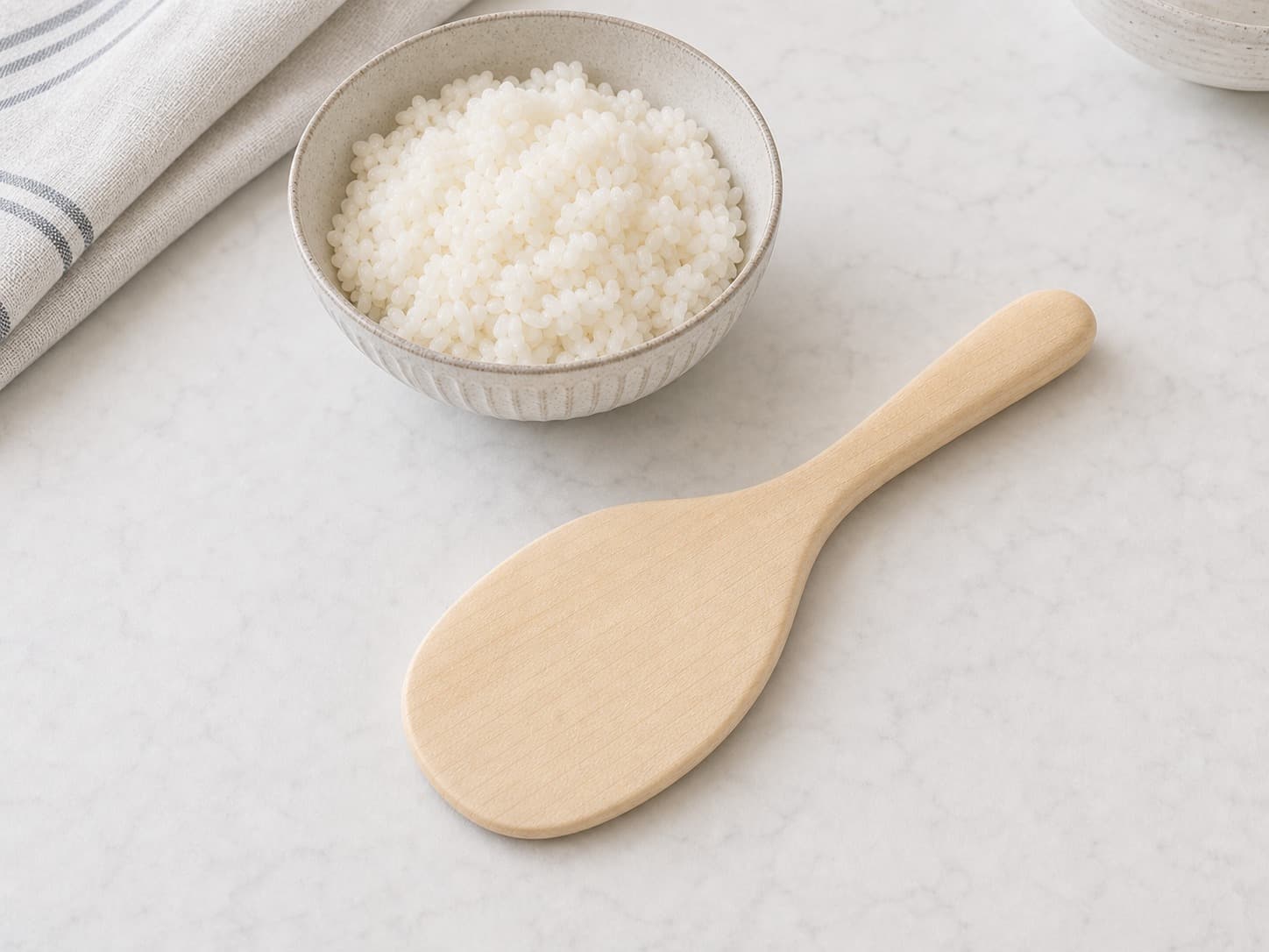 Rounded Maple Rice Paddle shown with everyday kitchen items for scale