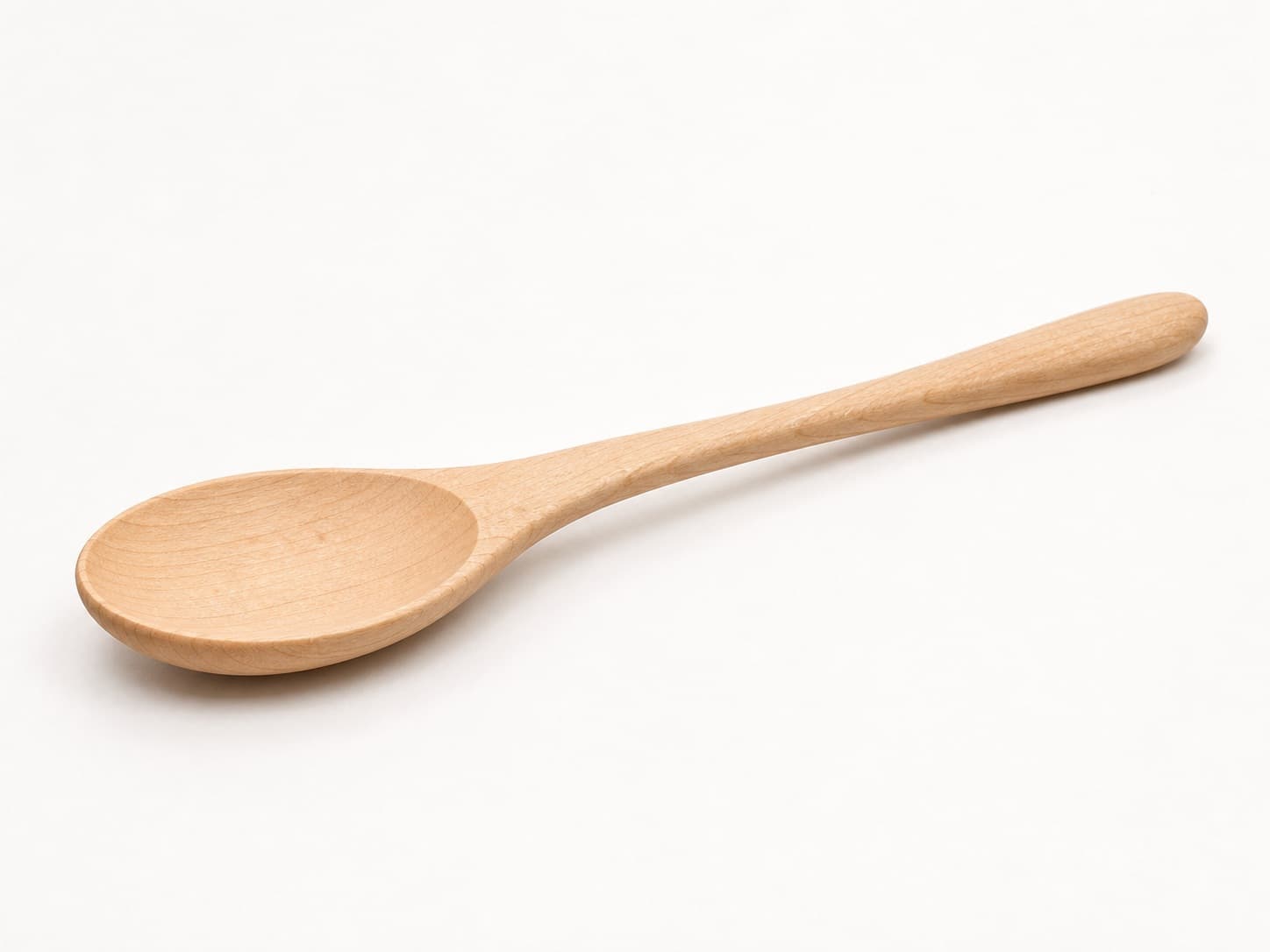 Low side angle showing the thickness and edge profile of Broad Serving Spoon