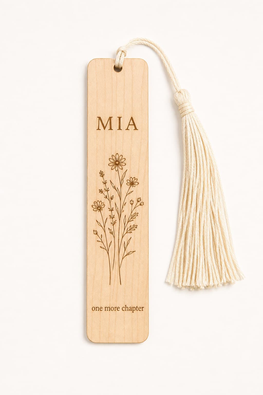Thin hard maple bookmark engraved with Mia wildflowers and one more chapter