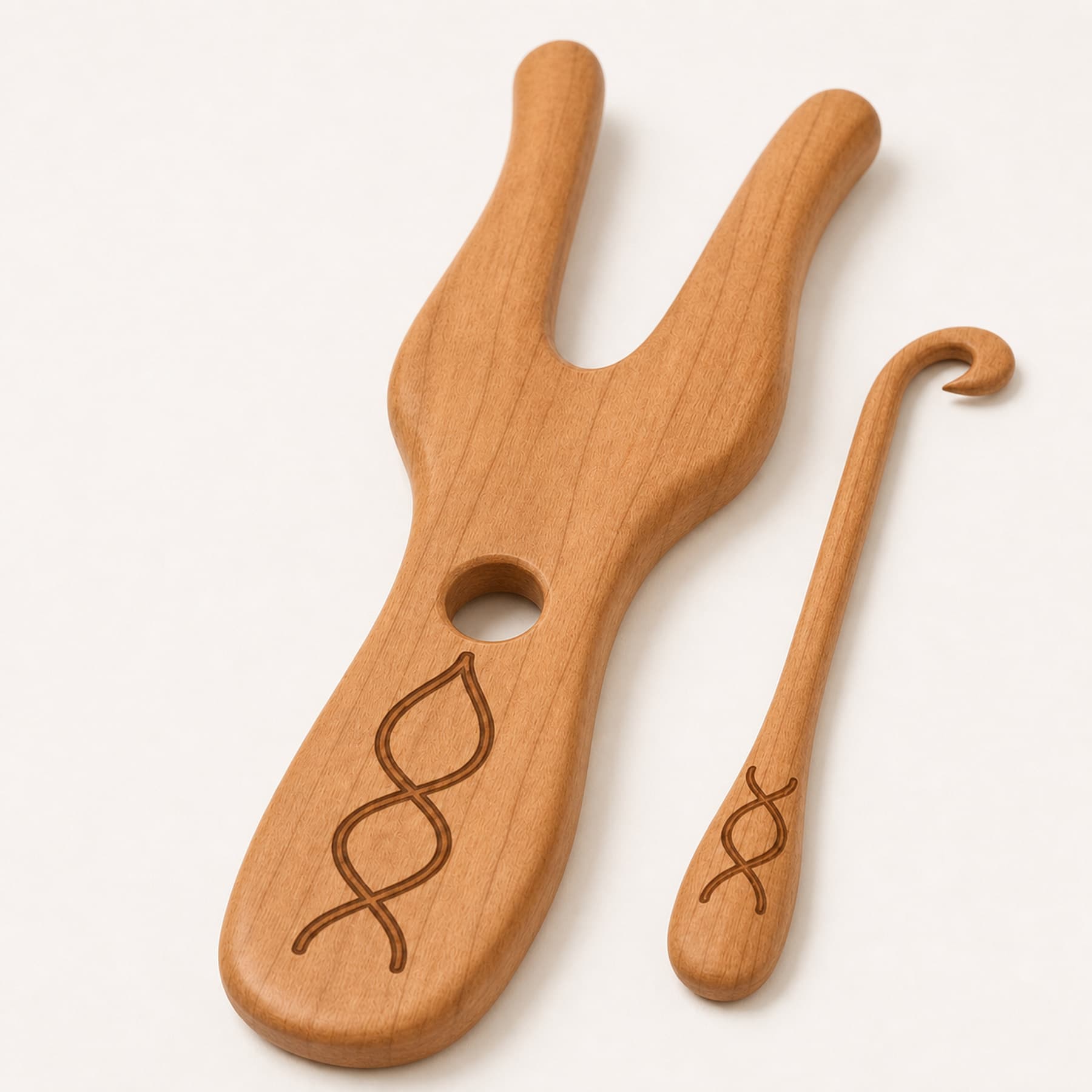 Close view of the rounded cherry edges, guide hole, hook, and laser engraving