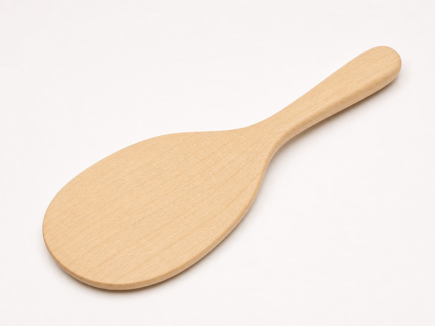 Hard maple rice paddle with a rounded oval paddle head and slim handle