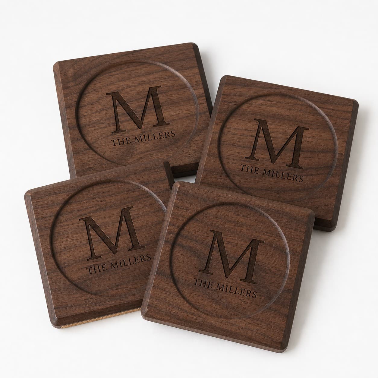 Set of four walnut coasters engraved with a monogram and family name