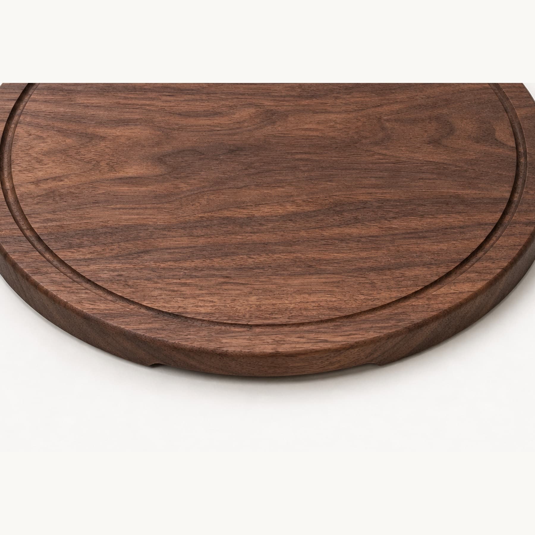 Low side angle showing the thickness and edge profile of Round Walnut Serving Board