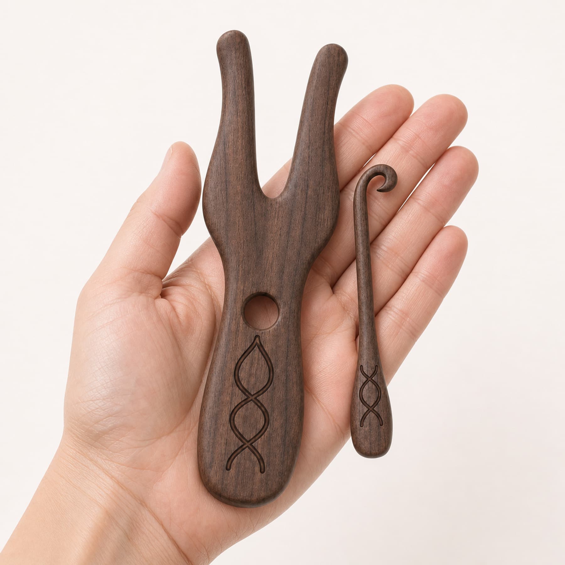 Seven-inch walnut lucet and four-and-a-half-inch loop lifter held for scale